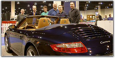 The Genesis Crew huddled around a sweet Porsche!